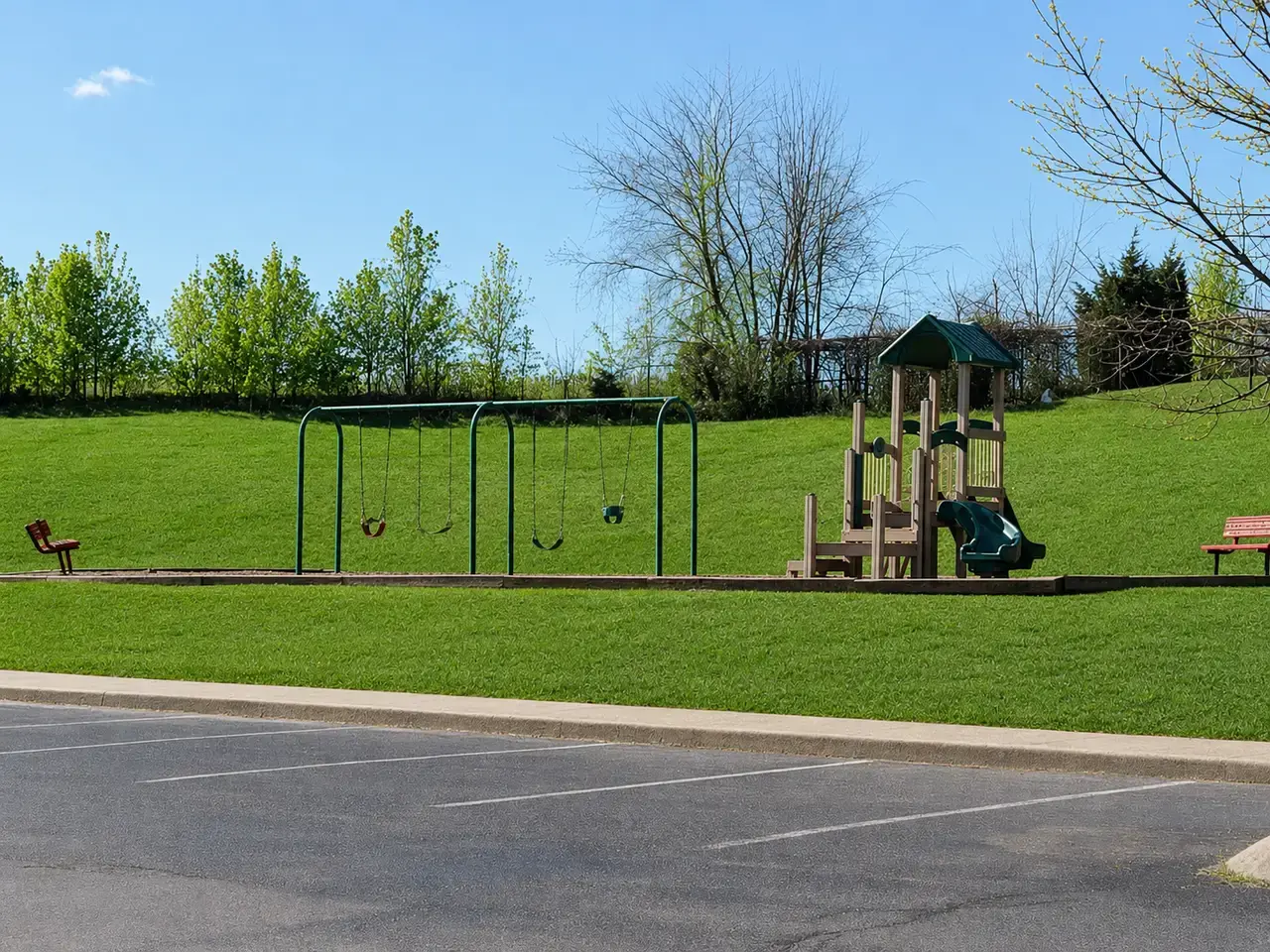Playground and swings on a wide lawn